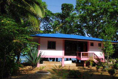Little pink house on stilts along the waterfront of Melekeok