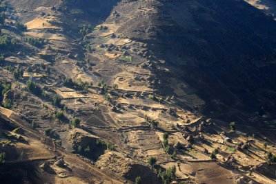 Dozens of native thatched rondavels among terraced fields within the park