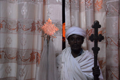 Priest with processional crosses, Bet Amanuel, Lalibela