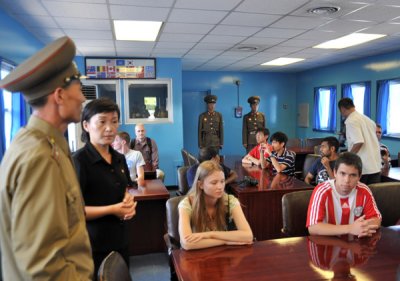 The conference table is set directly over the border