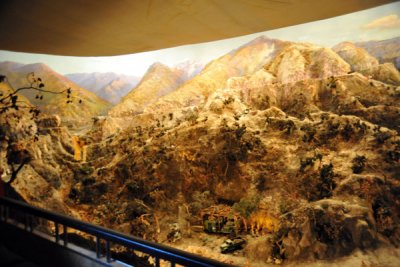 The diorama depicts the bravery of truck drivers delivering ammunition to the front under fire from U.S. Imperialist aircraft