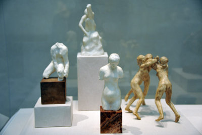 Small sculptures by Auguste Rodin - Female Torso, Woman seated with her foot in the air, Female Torso (ca 1910) and Three Faunes