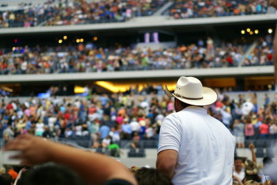 A lone cowboy watching the fans find their seats