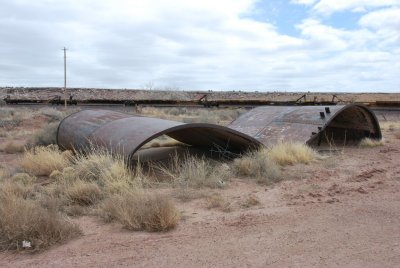 rusting water tank and parked intermodal cars