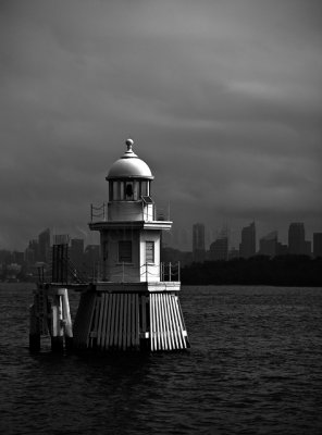 Marker on Sydney Harbour bathed in sunlight on a grey day