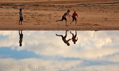 Boys at Narrabeen Lagoon with their reflection