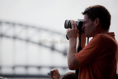 Tourist on Manly  ferry with Sydney Harbour Bridge backdrop