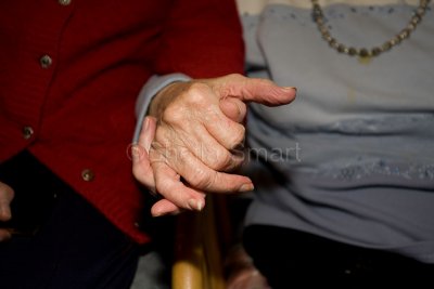 Aged couple holding hands