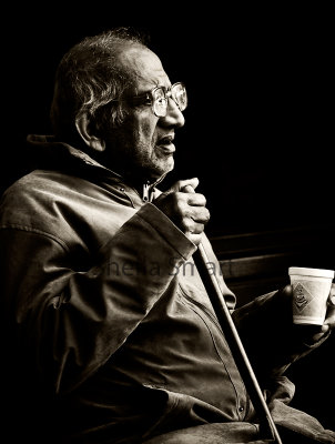 Man with glasses  and walking stick in monochrome