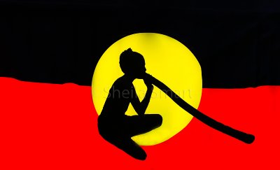 Aboriginal busker in flag