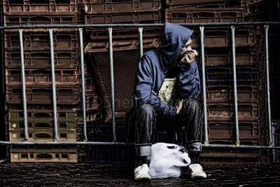 Man sitting next to crates