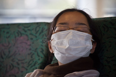 Girl in mask on ferry