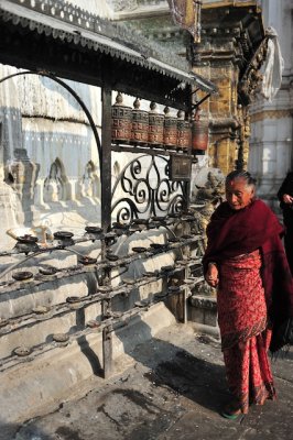 Lady ready to spin the prayer wheels at Bodhnath stupa.