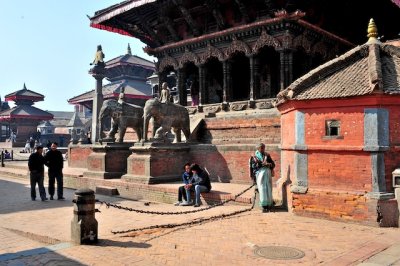 People sit around the temples in Patan.