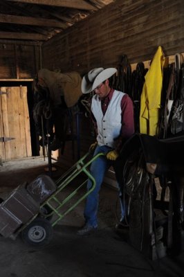 Seth loads mineral blocks on the dolly, then distributes them to the cattle.