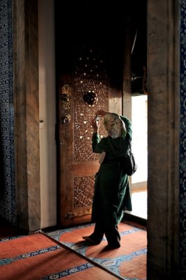 A tourist photographs details on the door of the Rutem Pasha mosque-.jpg