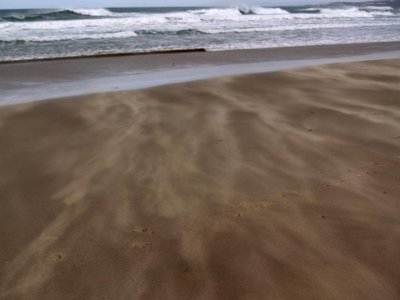 The wind was blowing out to sea...  Sand streaming past our feet the whole time...