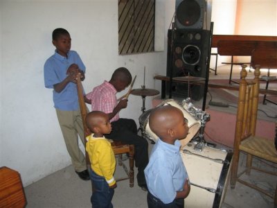 after church in Petionville, this small boy was playing the drums