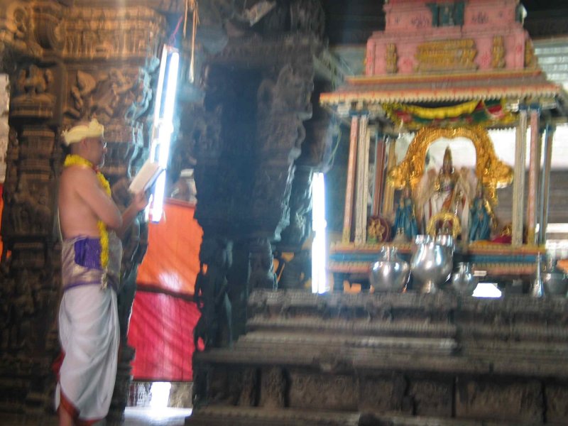  ... is reading the Kanci Sthala Puranam infront of Sri Devadhirajan