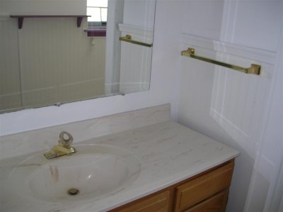 Gold fixtures and fake marble vanity top