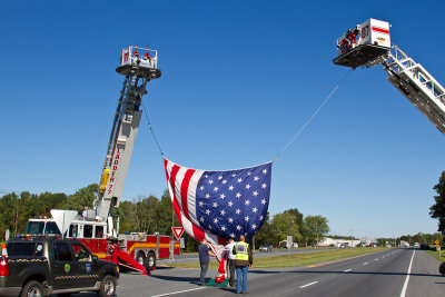 Firemen and police working to raise flag