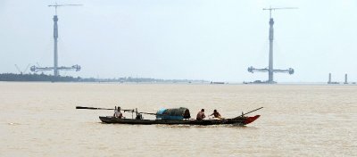 small boat in wide Mekong River