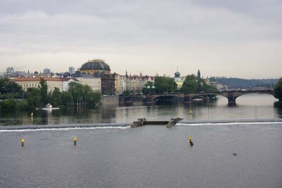 View of Vltava River from Charles Bridge looking at Legli Bridge.  Large building to left of bridge is the National Theatre.
