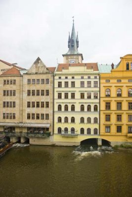 View of houses extending into river with passages beneath for water to go through