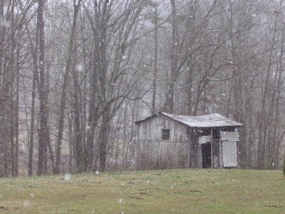 Barn under snow flurries