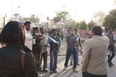 A phalanx of souvenir sellers accosting a group at the exit of the Agra Fort