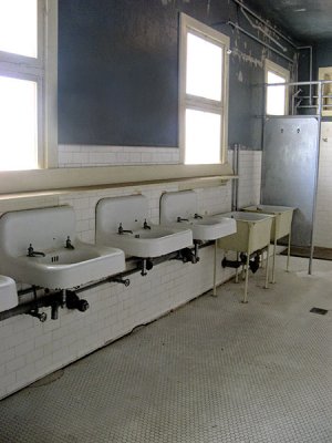 Wash basins with no mirrors. Women's restroom.