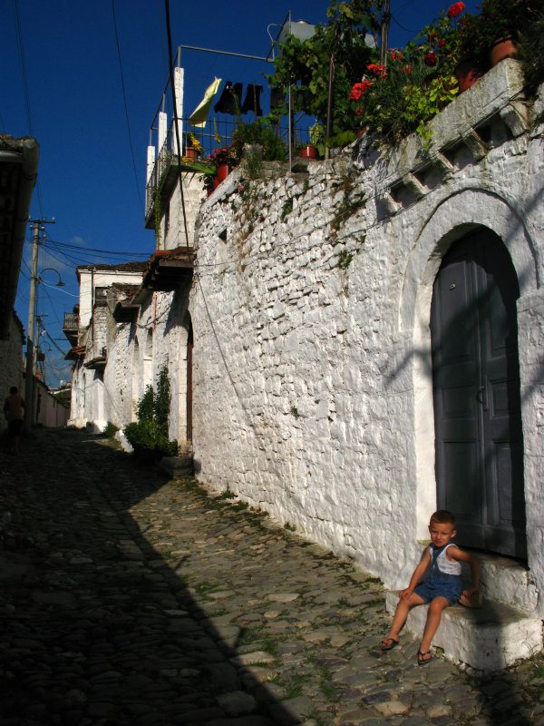 Boy sitting outside a house in Gorica