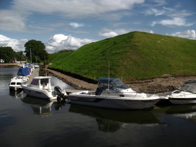 Boats beside the grass-covered castle ruins