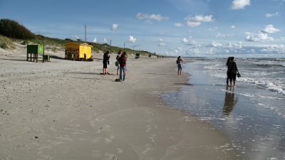 A few tourists out on the windy beach