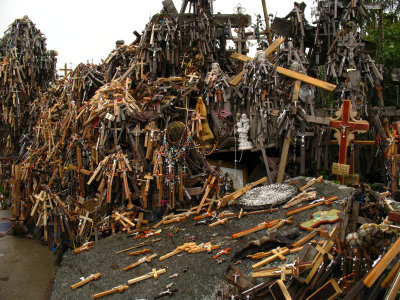 Piles of crosses beside a hilltop altar