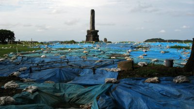 Excavation tarps on the former Hon-maru