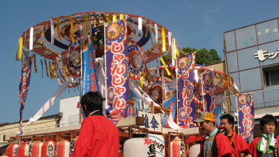 Ornamented umbrellas atop the floats