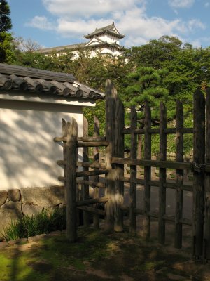Gate at the edge of garden with castle tower