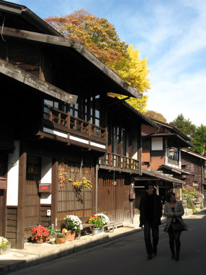 Couple walking past the old houses