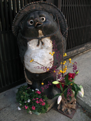 Ceramic tanuki and flowers