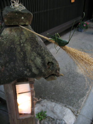 Grasshopper decoration on a stone lantern