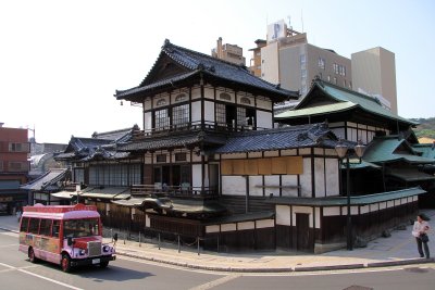 Retro tourist bus passing the Honkan
