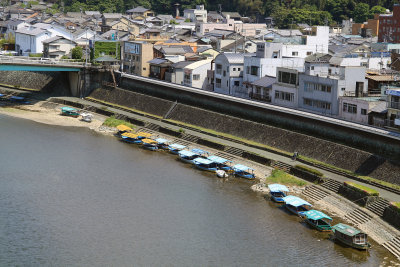 Row of ukai boats and nearby houses