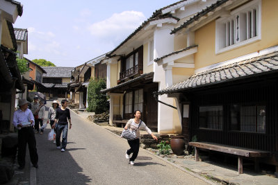 Girl running through Uchiko's restored old quarter