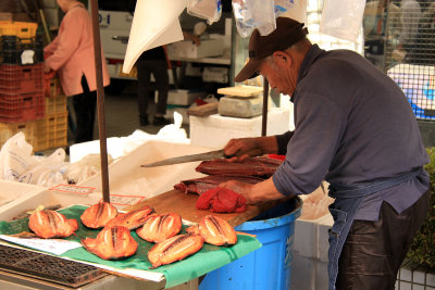 Preparing fish to grill outside Hirome Ichiba