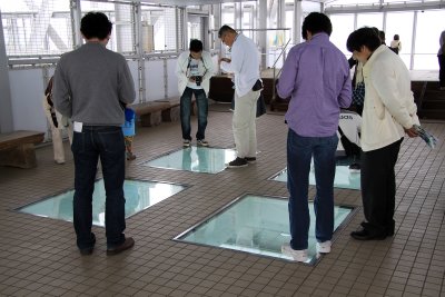 Tourists looking through the floor windows