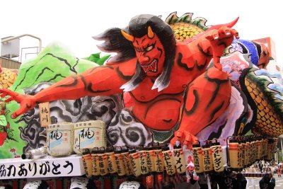 Demon figure atop the back of a float