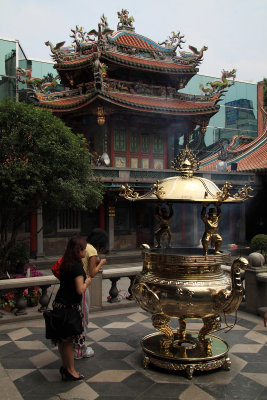 Praying beside one of the gold censers