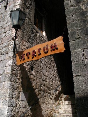 Sign and lantern above an alley