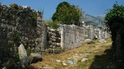 Crumbled stone walls along a footpath